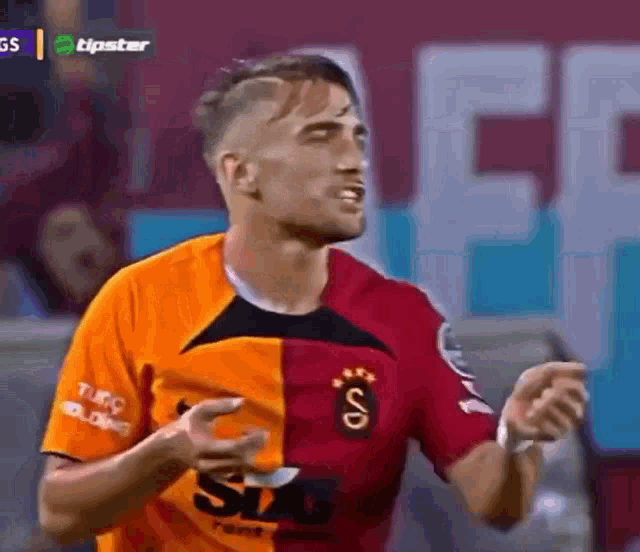 a soccer player is wearing a half orange and half red jersey with the word sd on it .