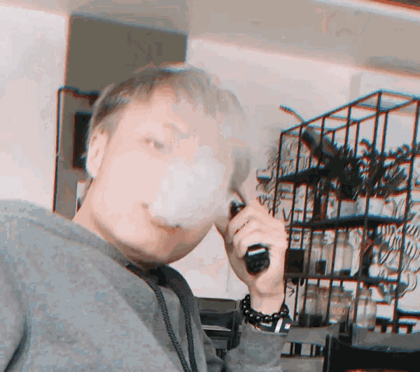 a man smoking a cigarette in front of a zebra display