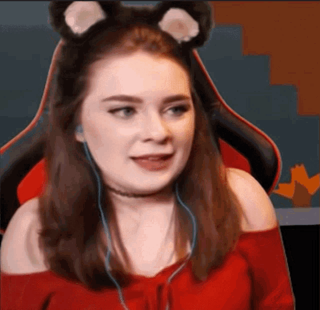 a woman wearing ear buds and a headband with cat ears