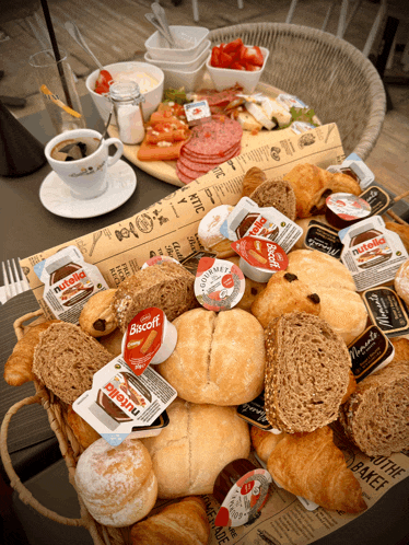 a basket of bread and pastries with nutella and biscoff on it