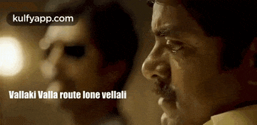 a man with a mustache is talking to another man in a movie .