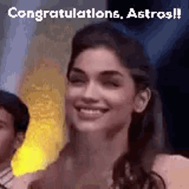 a woman is smiling and saying `` congratulations , astros '' .