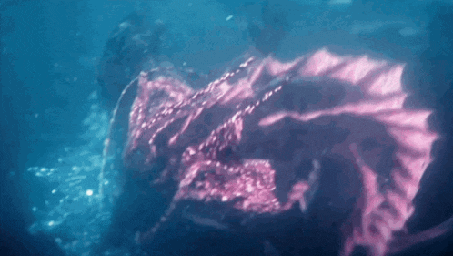 a person in a pink dress is floating in the water