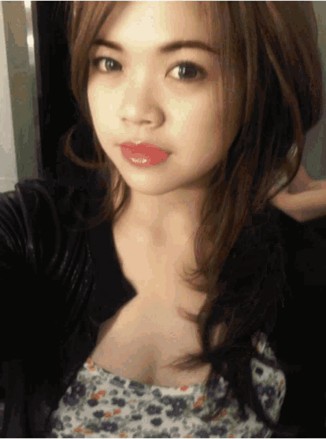 a close up of a woman taking a selfie with her hand on her neck