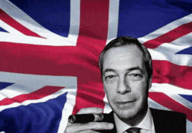a man holding a cigar in front of a flag