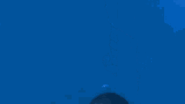a person is swimming in the ocean with bubbles coming out of it