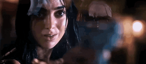 a close up of a woman 's face with a reflection of a person behind her .