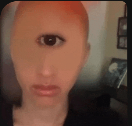 a close up of a person 's face with a third eye on it