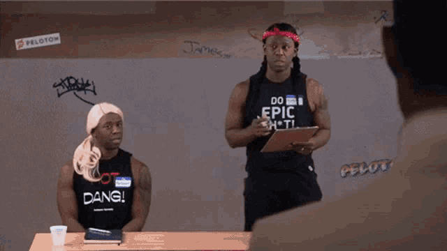 a man wearing a shirt that says do epic shit is standing next to another man