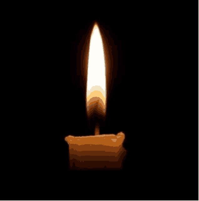 a single candle is burning in the dark