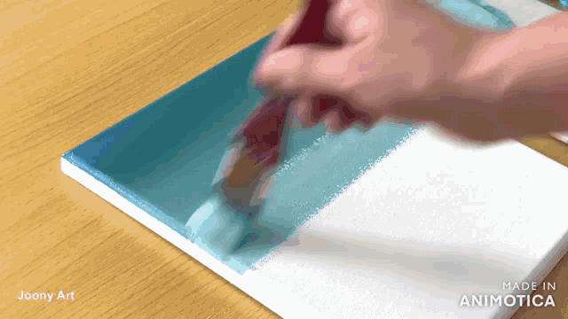 a person is painting on a canvas with the words made in animatica visible