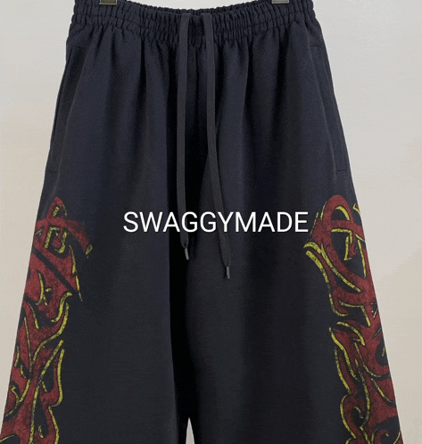 a pair of black shorts that say swaggymade on the front