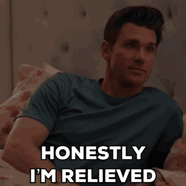 a man laying on a bed with the words honestly i 'm relieved
