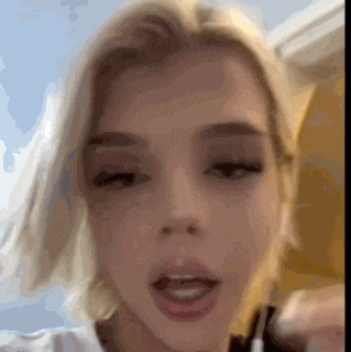 a close up of a woman 's face with a blurry background