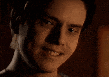 a close up of a man 's face with a smile