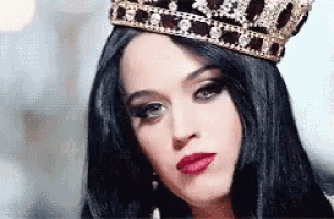 a woman is wearing a crown on her head .