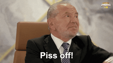 a man in a suit and tie with the word piss off on his face