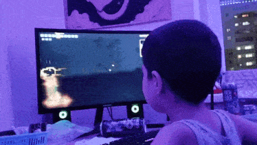 a person playing a game on a computer with a can of fresh bar in front of them