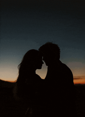 a silhouette of a man and woman kissing with the words je t 'aime