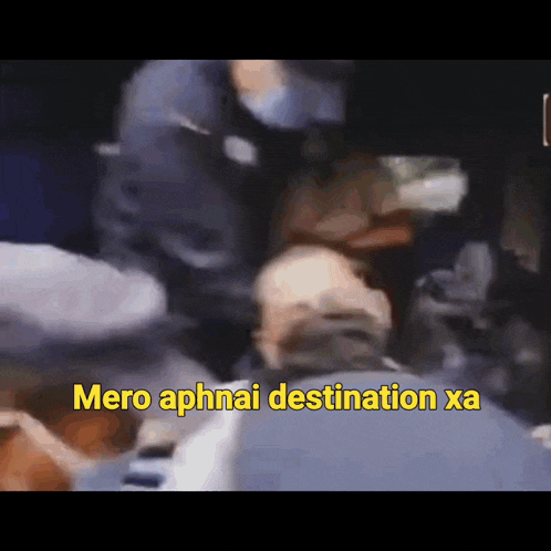 a blurred image of a man with the words " mero aphnai destination xa " written in yellow