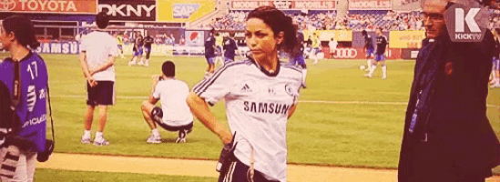 a woman in a samsung jersey stands on the field