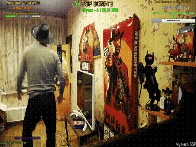 a man is dancing in a room with a red dead redemption poster on the wall