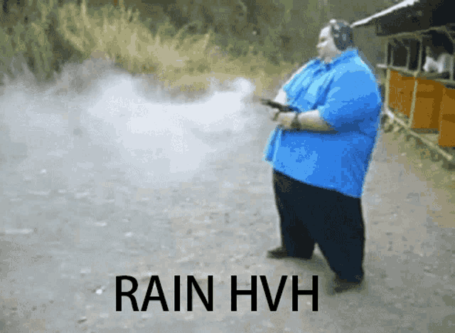 a man in a blue shirt is holding a gun and says rain hvh