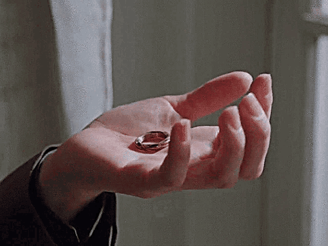 a person holding a ring in their hand