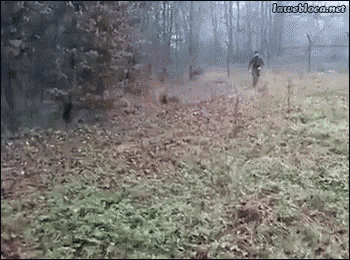 a man is riding a motorcycle through a field with trees in the background