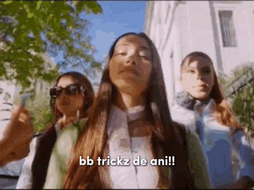 a group of girls are standing next to each other on a sidewalk .