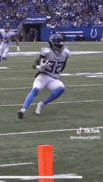 a football player running with the ball on a field