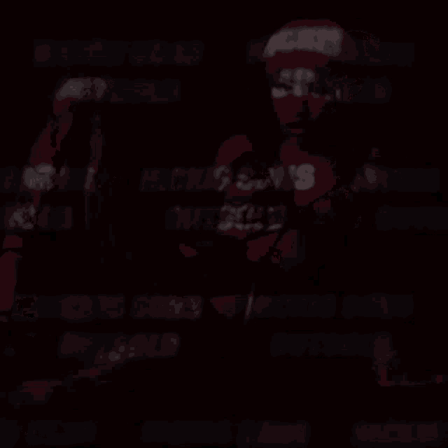 a blurred image of a person with the words " wick 's sons " written on their shirt