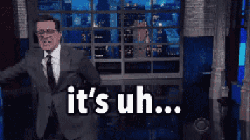 a man in a suit and tie says it 's uh on a stage