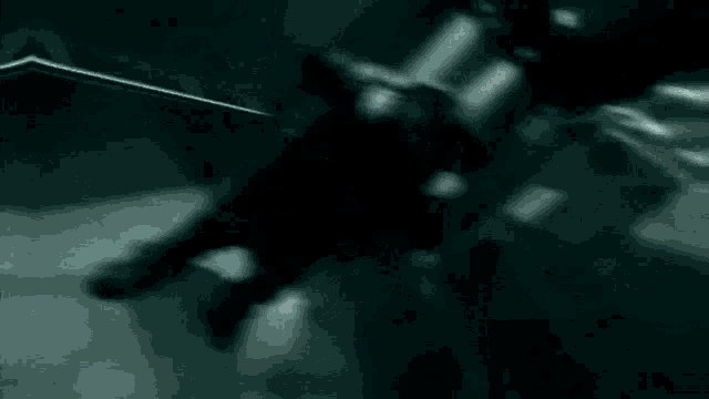 a man is holding a knife in a dark room in a video game .