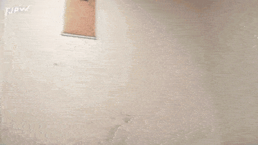 a person is standing in a doorway with a clipboard on the wall .