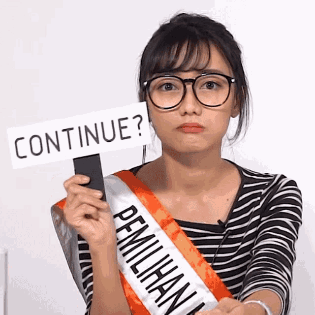 a woman wearing glasses and a sash that says continue