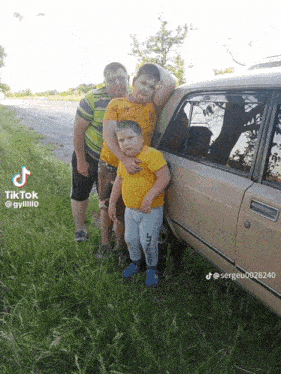 three boys are posing for a picture next to a car with tiktok written on the bottom right corner
