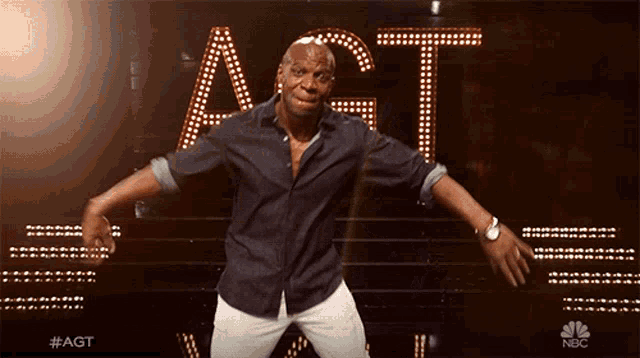 a man dancing in front of a sign that says act