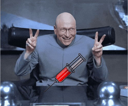 a man giving a peace sign next to a syringe with a red liquid on it