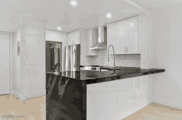 a kitchen with white cabinets and a stainless steel stove