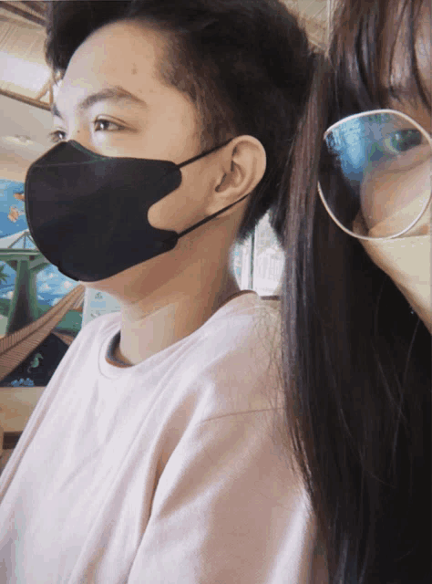a man and a woman wearing face masks and glasses