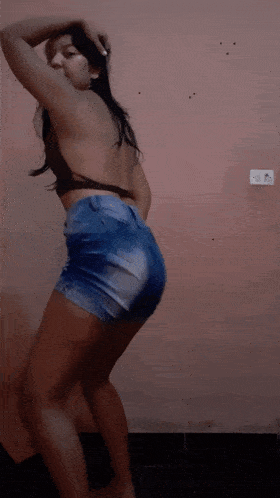 a woman in a crop top and shorts dancing