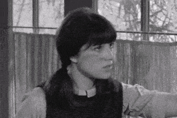 a black and white photo of a girl with pigtails and a ponytail .