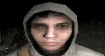 a man wearing a hoodie is making a funny face .