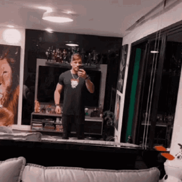 a man is taking a selfie in front of a mirror