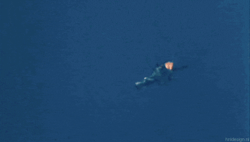 a flame is coming out of a blue object in the sky