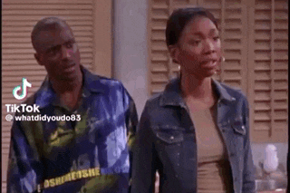 a man and woman are standing next to each other in a room .
