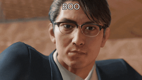 a man wearing glasses has the word boo on his forehead