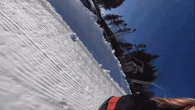 a person walking in the snow with a sign that says ' lodge ' on it
