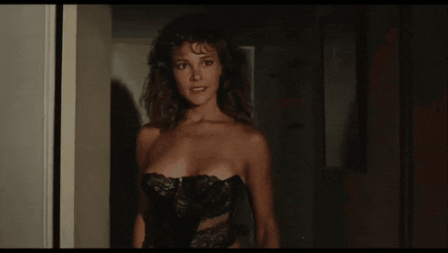 a woman in lingerie is standing in a doorway with the words but its above her